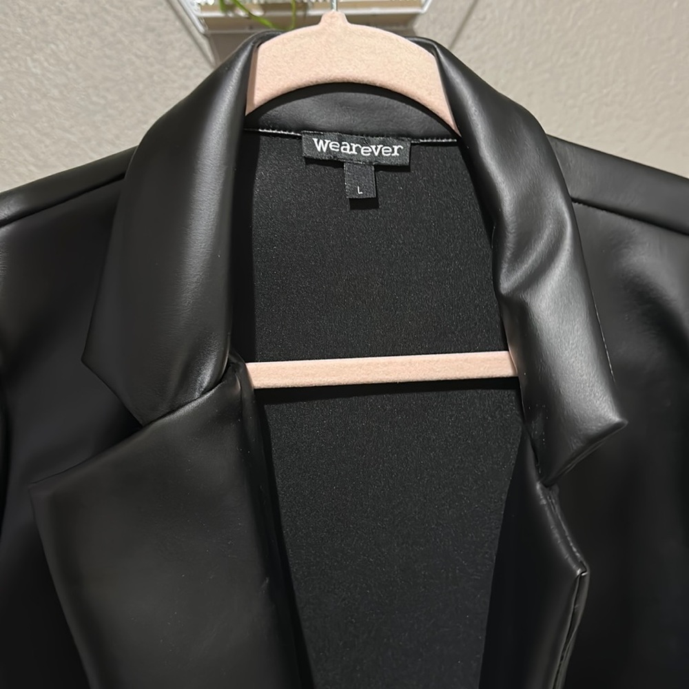 A Blake faux leather blazer with rolled sleeves.